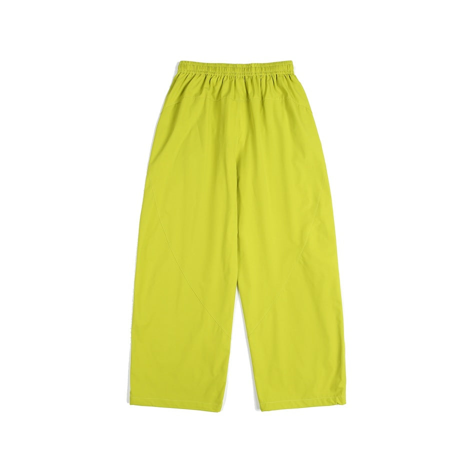 Bright lime yellow loose straight-leg pants with an elastic waistband, shown against a white background.