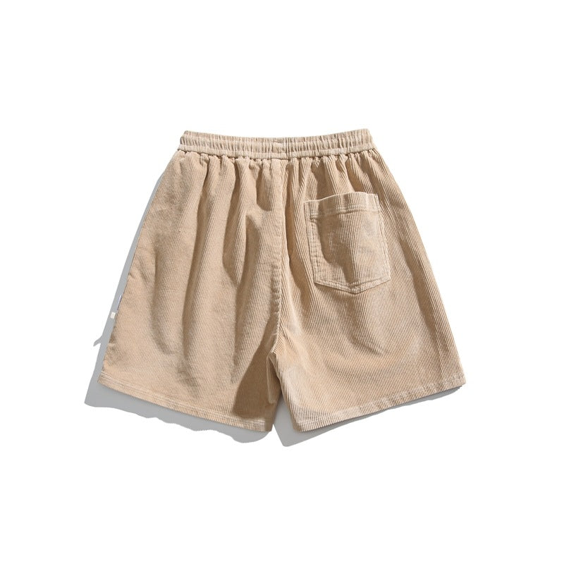 Light beige corduroy shorts shown from the back, with an elastic waistband and one patch pocket.