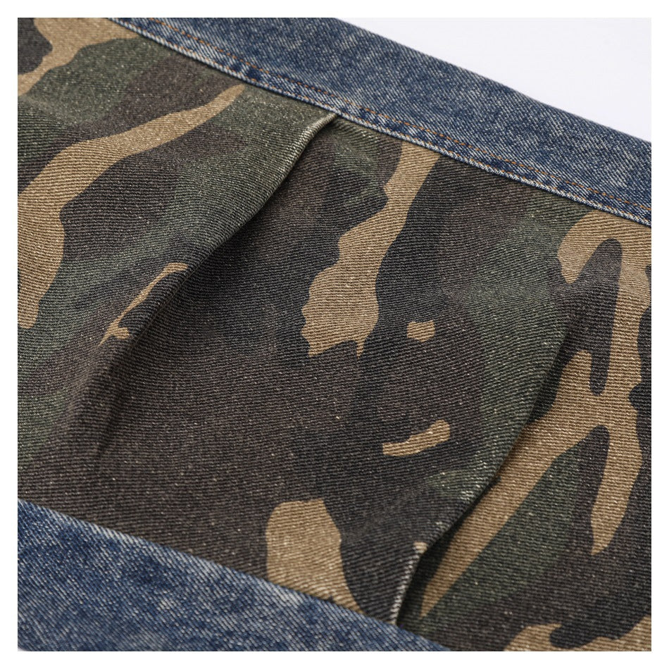 Close-up of a camouflage fabric panel bordered by blue denim.