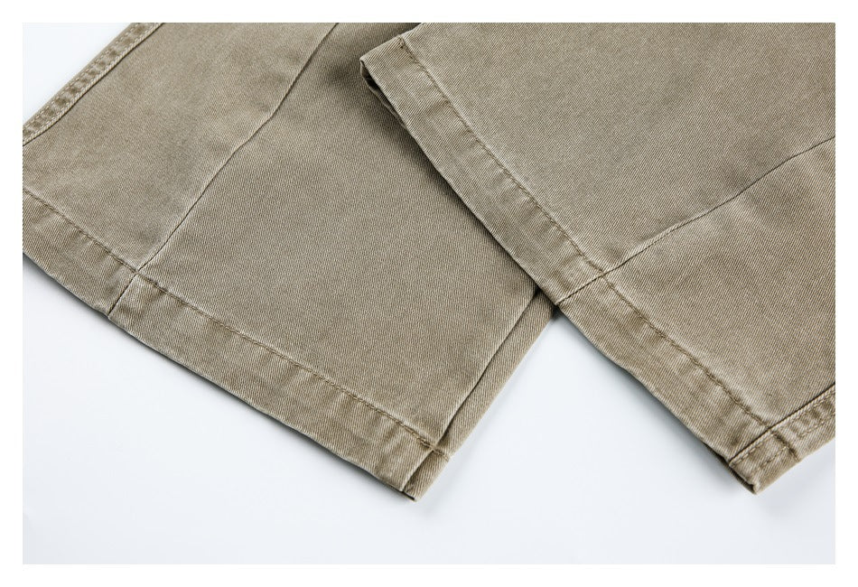 Close-up of two khaki trouser hems with visible stitching on a white background.