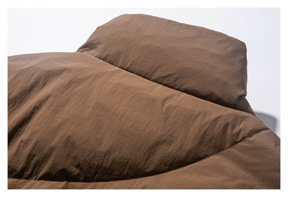 Close-up of the brown jacket's padded hood and surrounding stitched panels.
