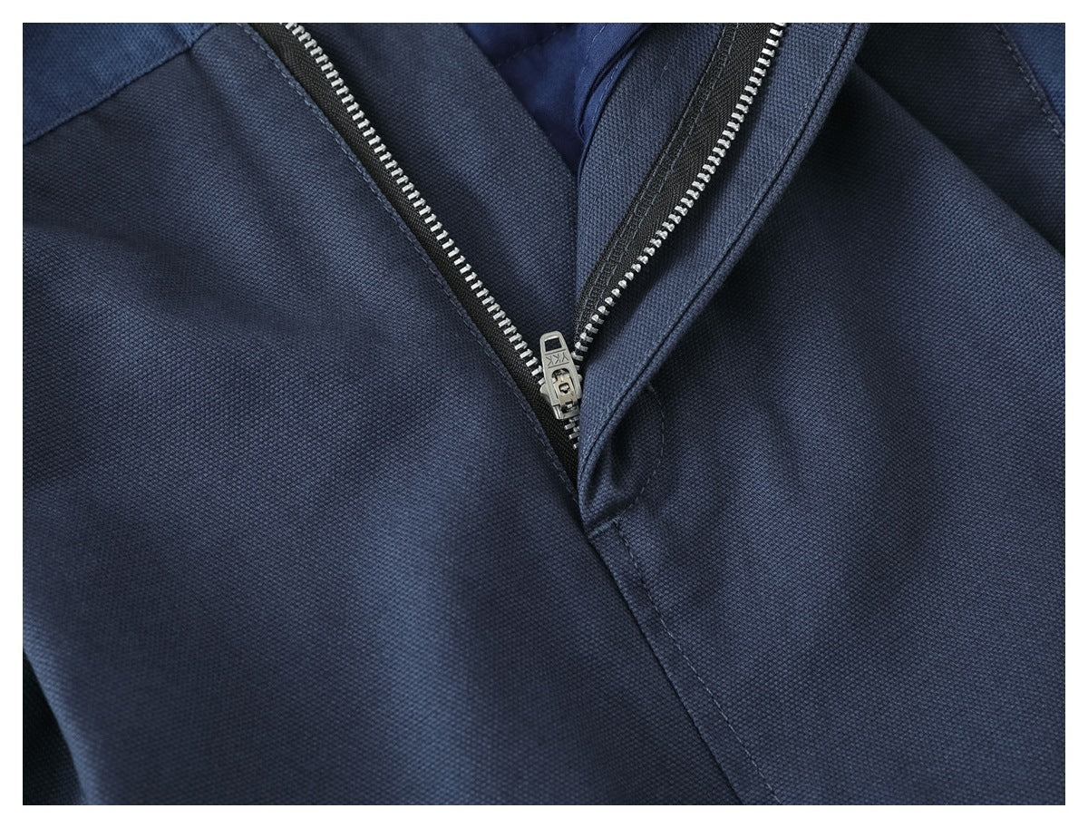 Close-up of blue trousers showing the partially open front zipper and stitching.