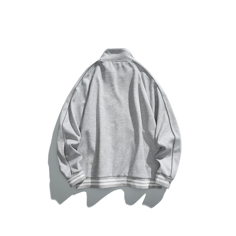 Back view of a light gray track jacket laid flat, with curved sleeve seams and striped cuffs and hem.