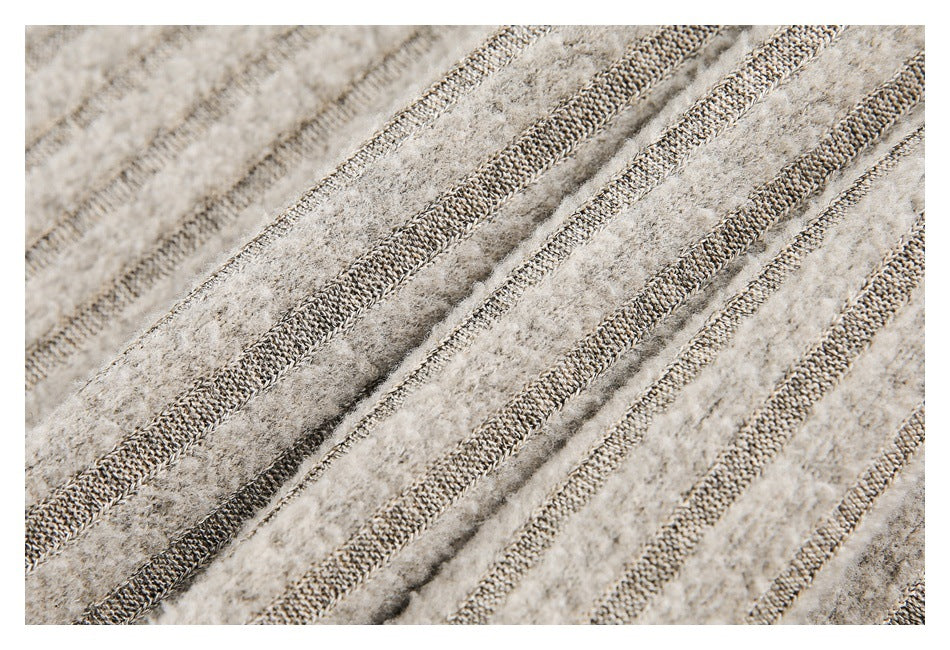 Close-up of beige fuzzy knit with narrow textured rib stripes.