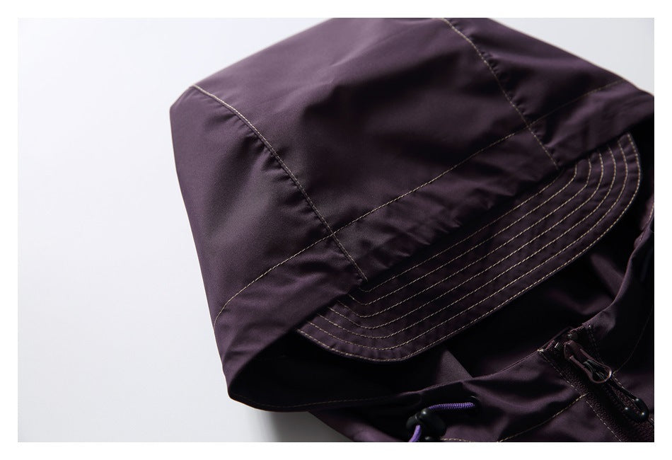 Close-up of the jacket's dark plum hood, showing curved panels and rows of topstitching.