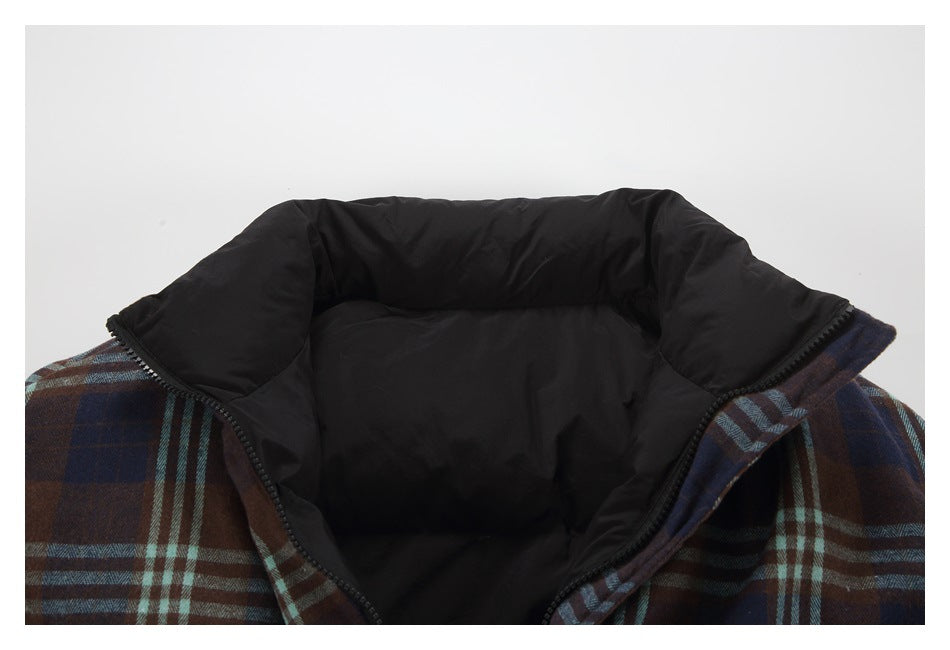 Close-up of an open plaid jacket with a black padded inner collar and lining.
