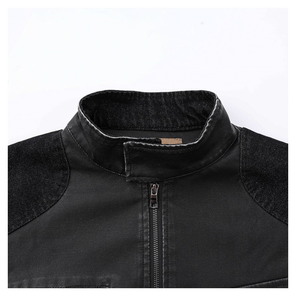 Close-up of the black jacket's stand collar, front zipper, and contrasting dark denim shoulder panels.
