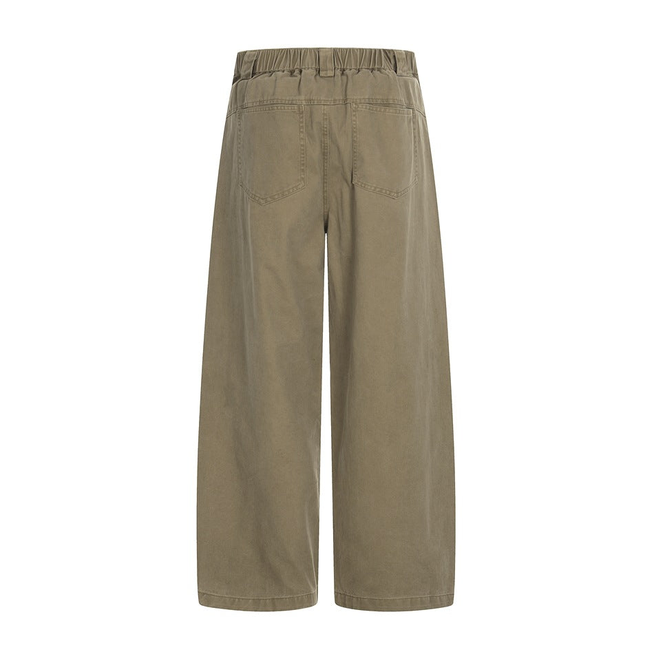 Back view of taupe wide-leg trousers with an elasticated waistband and two rear patch pockets.