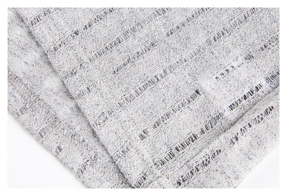 Close-up showing the light gray open-knit fabric's ladder-like gaps, texture, and seam.