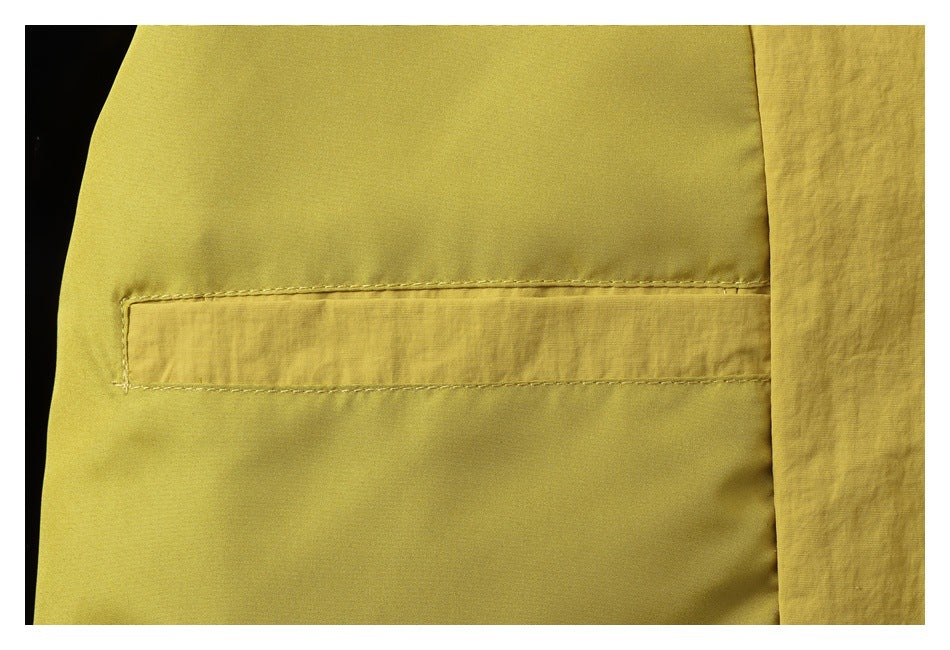 Close-up of a horizontal welt pocket on mustard-yellow garment fabric.