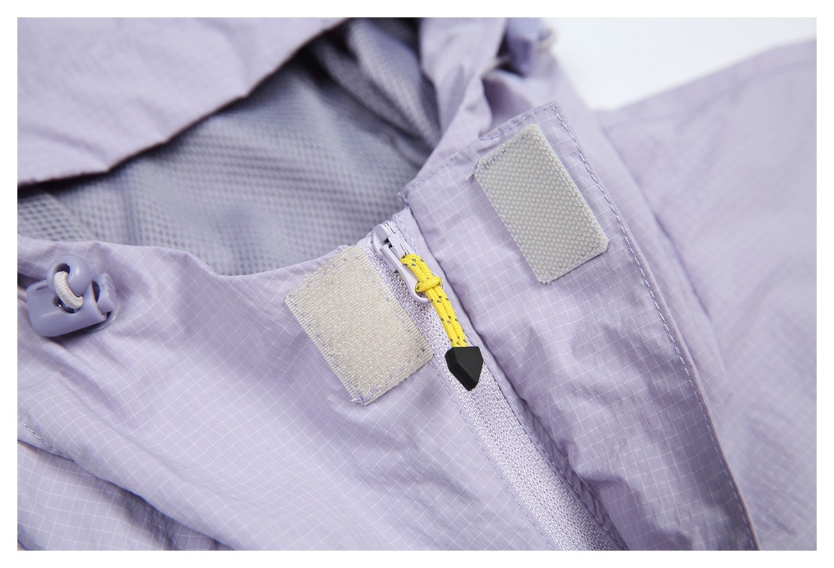 Close-up of a lavender grid-patterned garment zipper with yellow pull, hook-and-loop tabs, and mesh lining.