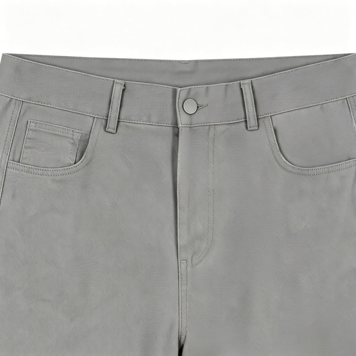 Close-up of gray trousers showing the front waistband, button, belt loops and curved front pockets.