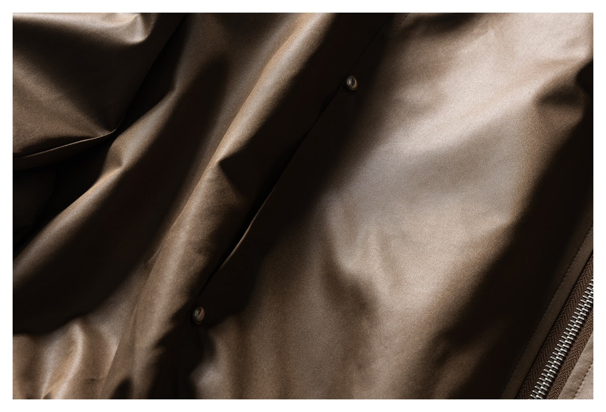 Close-up of the brown jacket's snap-button front placket and zipper edge.