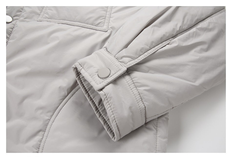 Close-up of the light gray jacket sleeve cuff with a snap button and stitched adjustment tab.