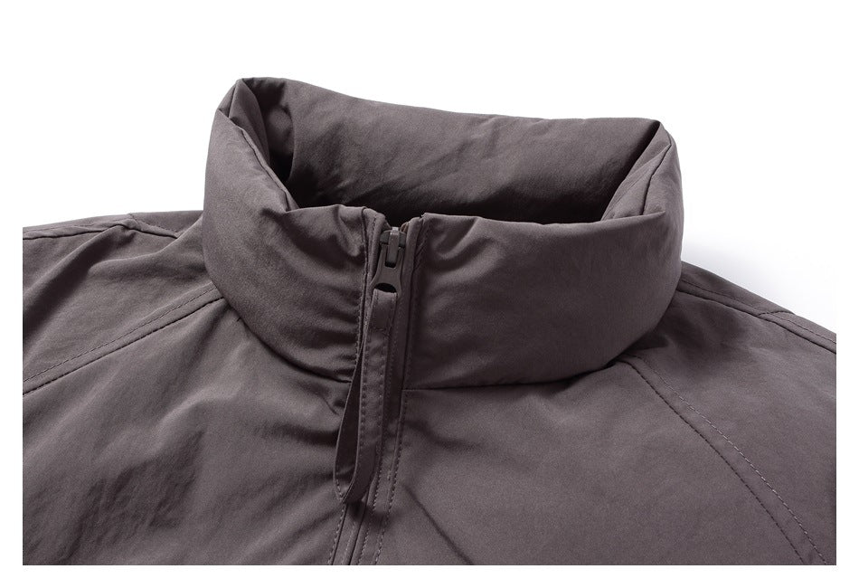 Close-up of the jacket’s high stand collar, front zipper, and shoulder stitching.