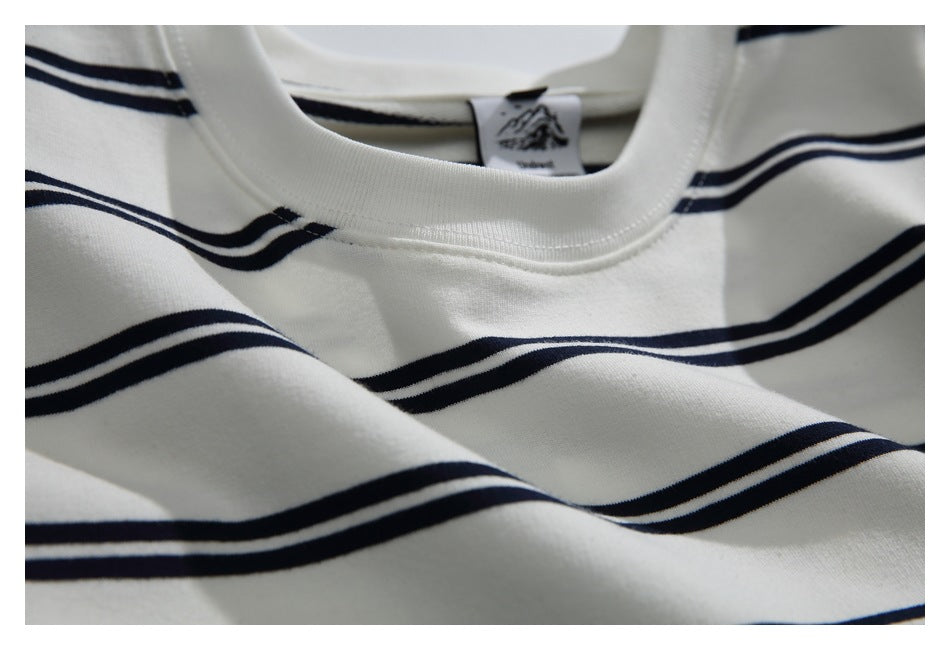 Close-up of the ribbed crew neckline, navy stripes, and sewn-in neck label.