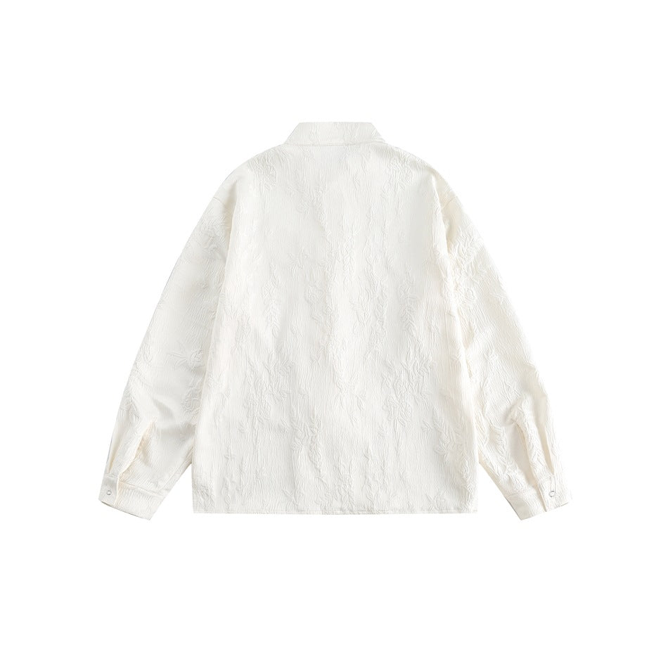 Back view of an ivory long-sleeved shirt with a stand collar, button cuffs, and an embossed floral pattern.