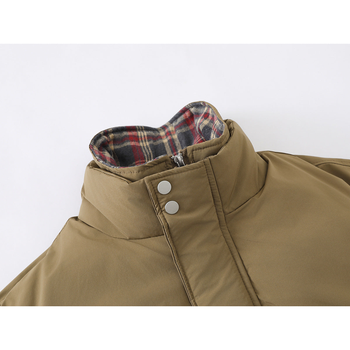 Close-up of a tan jacket's high collar, showing red, gray, and cream plaid lining, zipper, and silver snap placket.
