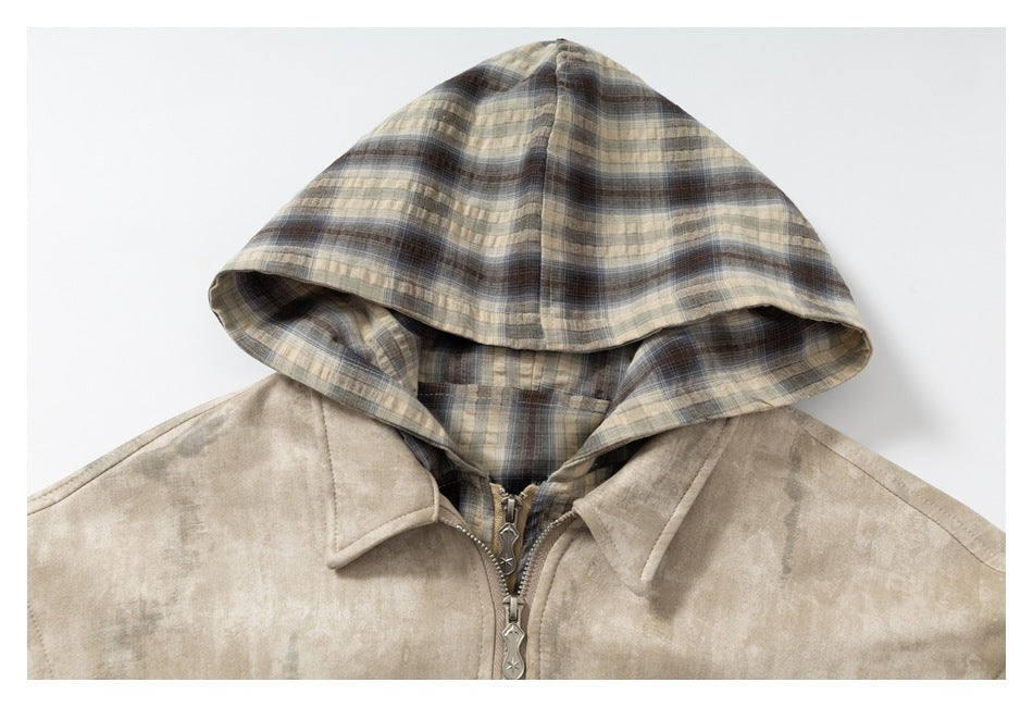 Close-up of a beige mottled jacket showing its plaid hood, wide collar and front zipper.