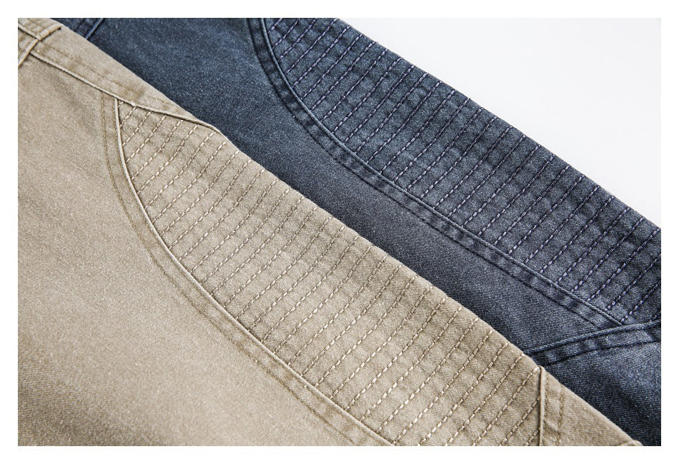 Close-up of tan and dark blue jacket panels with rows of parallel stitching.