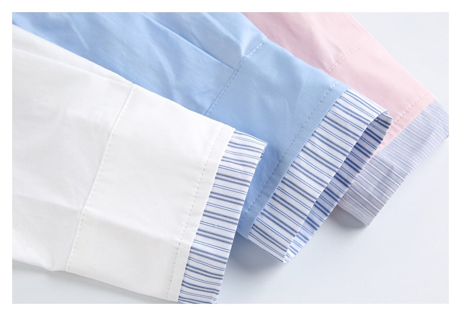 White, light blue, and pink shirt sleeves with blue-and-white striped cuffs arranged together.