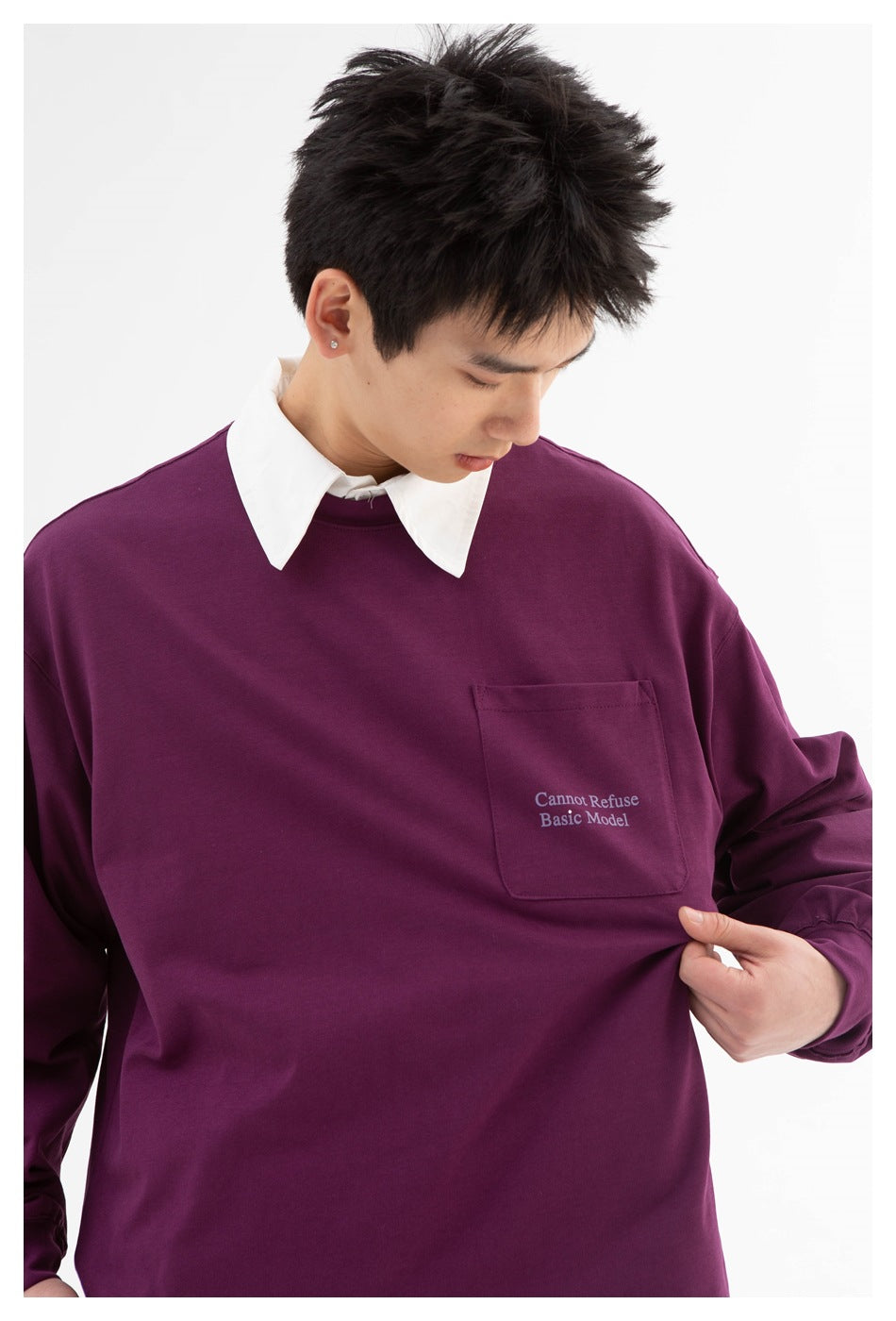 Front view of a model in a plum long-sleeve sweatshirt with a chest pocket, small English text, and a white collar.