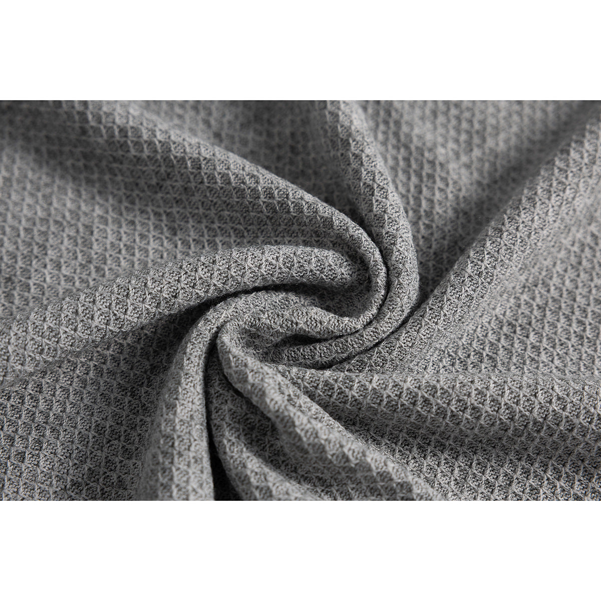 Close-up of gray textured knit fabric gathered into folds.