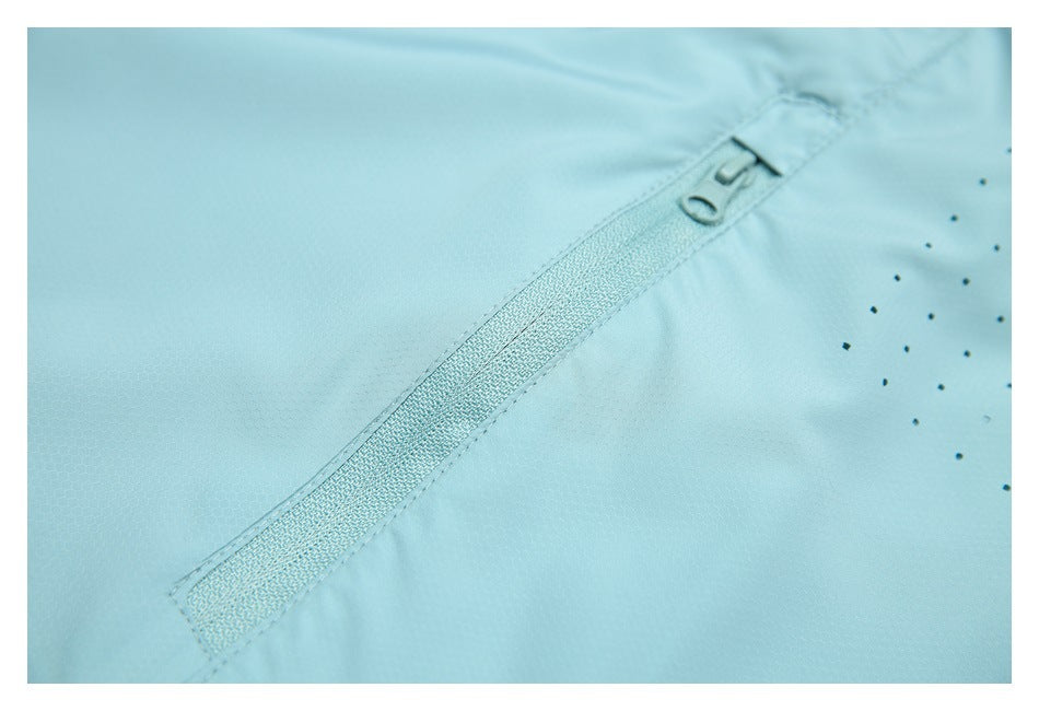 Close-up of an aqua zipper set into matching fabric, with scattered dark dots nearby.