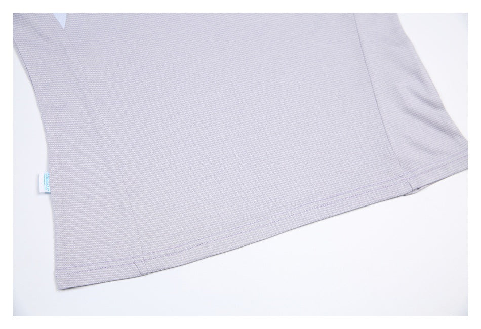 Close-up of the shirt's lower hem and side seam, with a small COOLMAX tag at the edge.