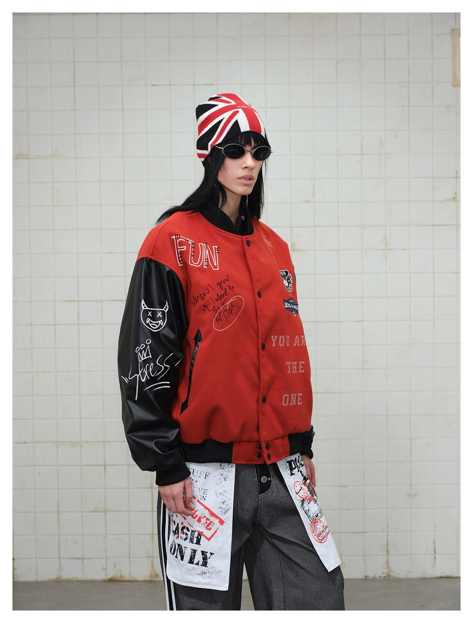 Model wearing the red and black varsity jacket, side view with graffiti embroidery and sleeve artwork