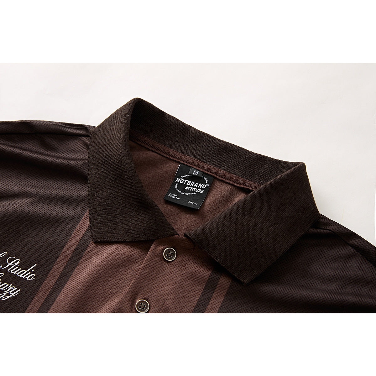 Close-up of a dark brown striped polo shirt collar, buttons and inner neck label.