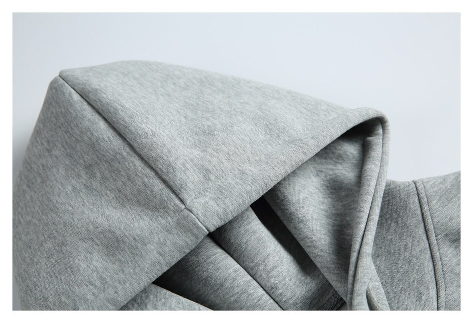 Close-up of the heather gray hoodie’s sewn hood and inner lining.