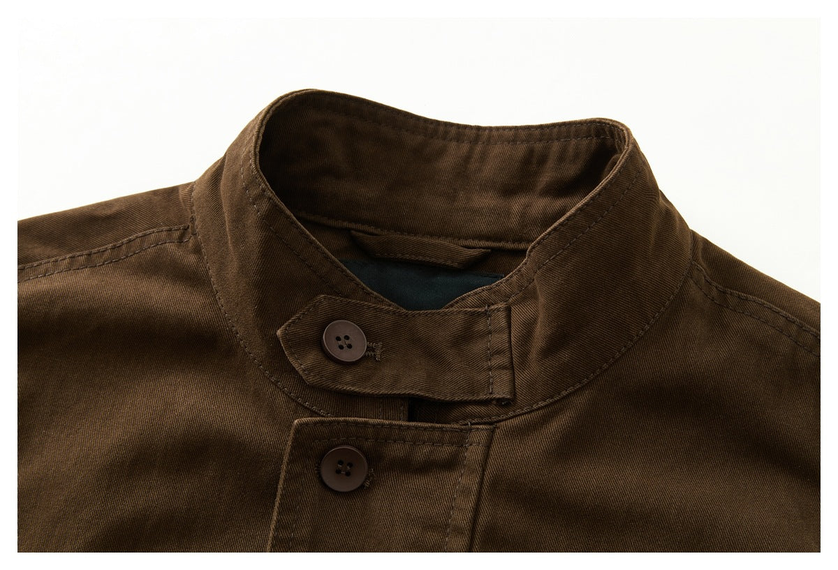 Close-up of the dark brown jacket's stand collar and buttoned throat tab.