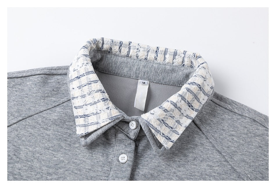 Close-up of the pullover's patterned collar, gray neckline, white buttons, and size M tag.