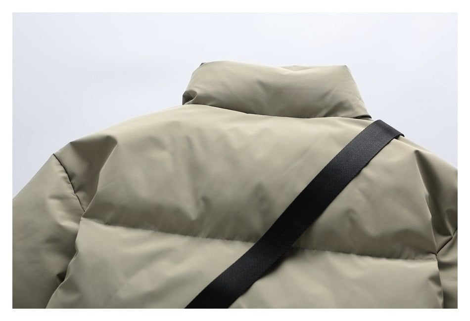 Cropped back view of an olive-khaki puffer jacket with a raised collar and black diagonal strap.