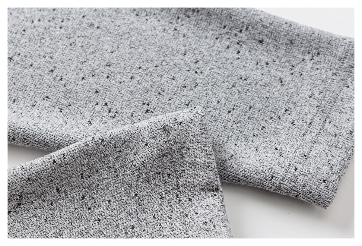 Close-up of the gray flecked sweater’s sleeve and ribbed cuff.