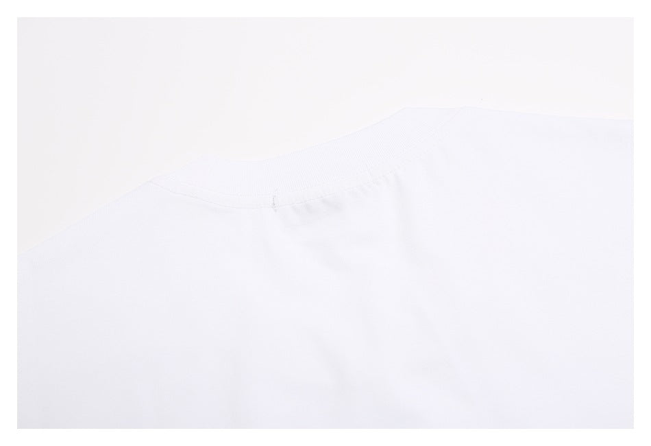 Close-up of the white T-shirt's ribbed crew neckline and back collar seam.