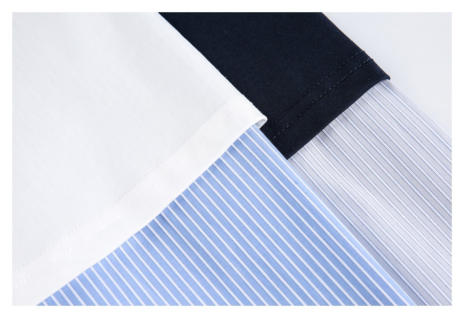 Close-up of white and navy fabric edges over a blue-and-white striped shirt panel.
