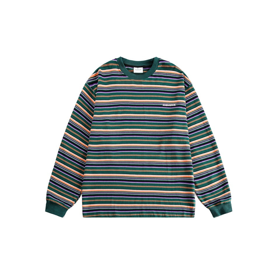 Green long-sleeve crew neck top with orange, purple, black and white horizontal stripes, flat lay front view