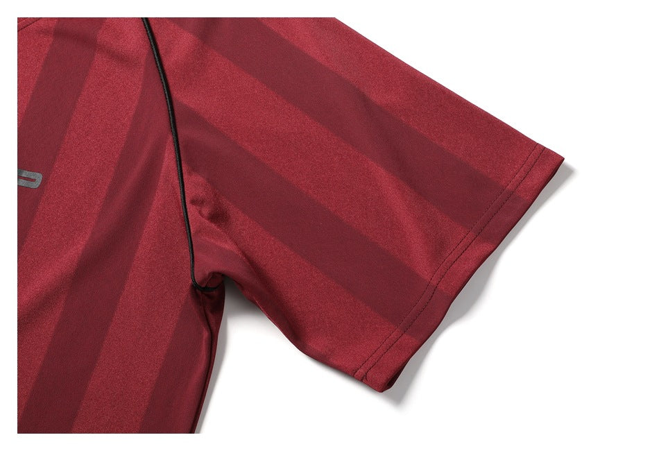 Close-up of a burgundy striped short sleeve with black piping and a neatly finished hem.