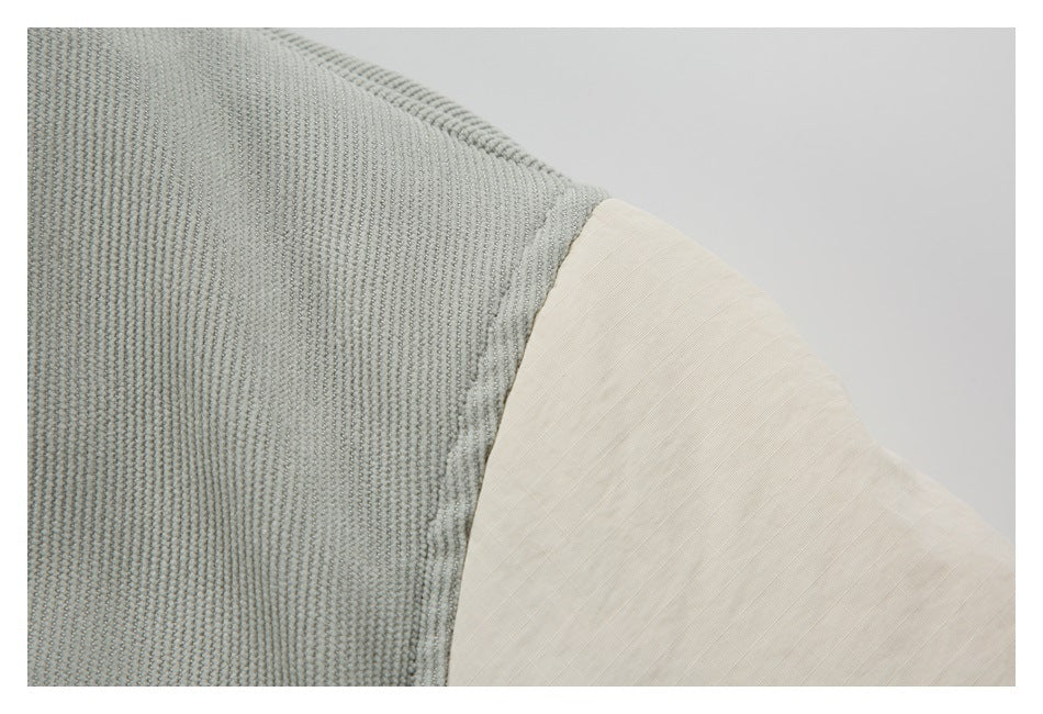 Close-up of the gray textured jacket fabric meeting a cream shoulder panel.