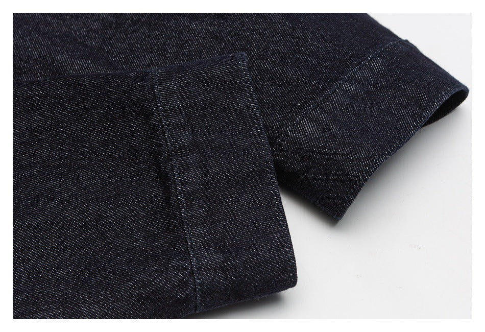 Close-up of dark indigo denim sleeve cuff and stitched hem.