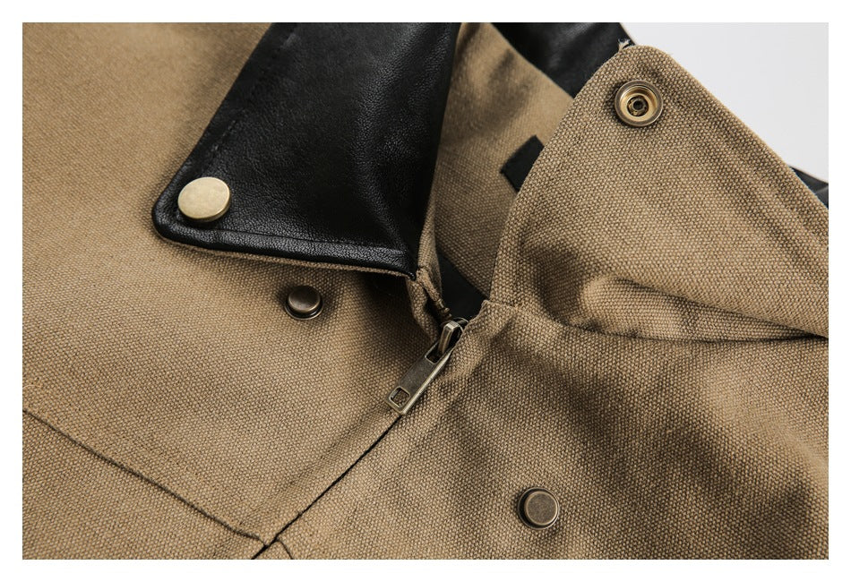 Close-up of a tan jacket with a black collar, zipper, and metal snap fasteners.