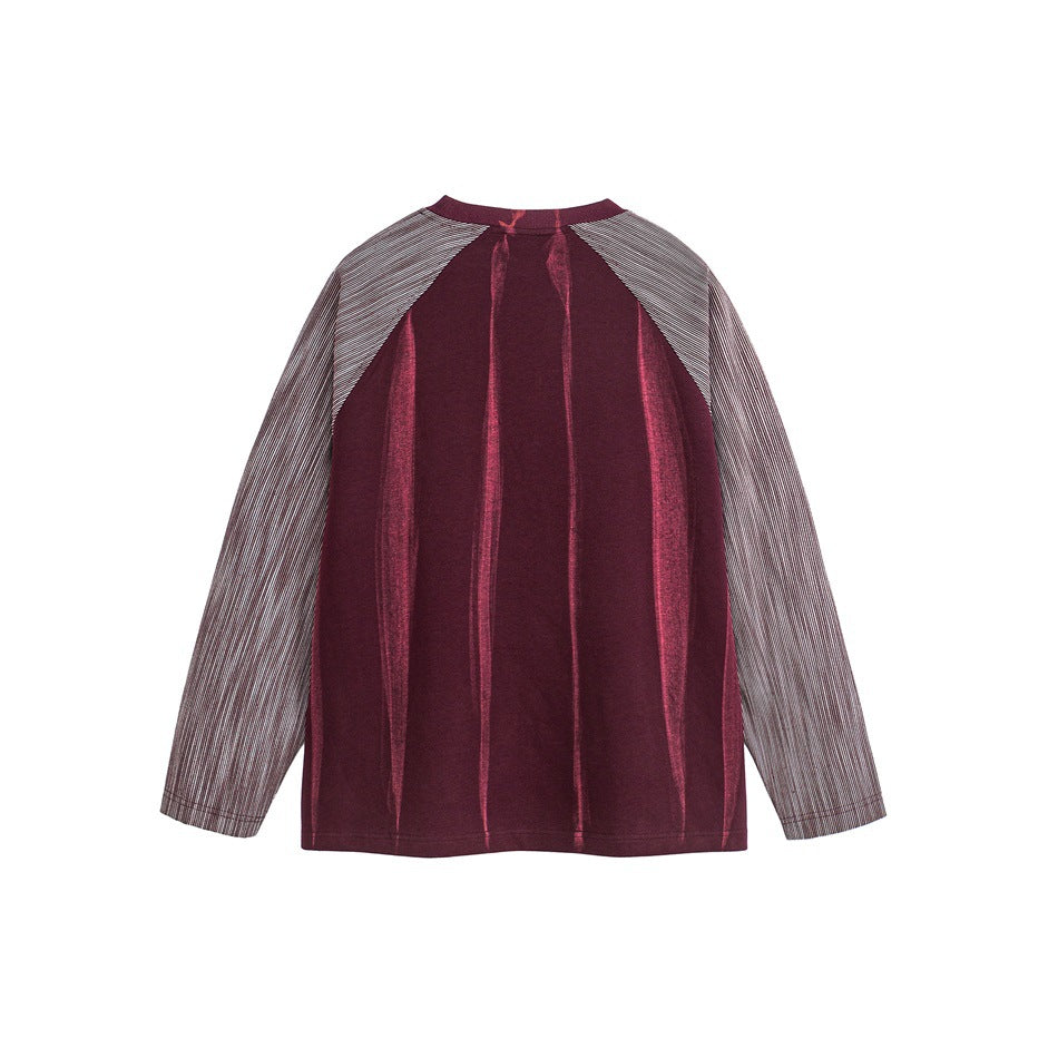 Back view of a burgundy long-sleeve top with gray pinstriped raglan sleeves and vertical tonal detailing.