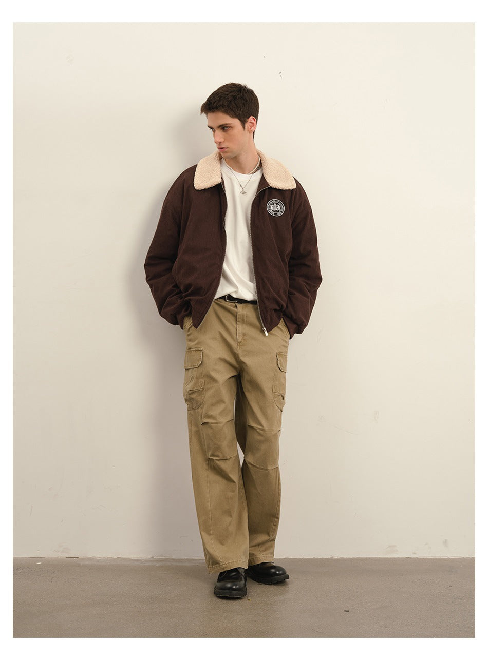 Model wearing khaki cargo pants and a dark brown jacket with a cream collar over a white T-shirt.