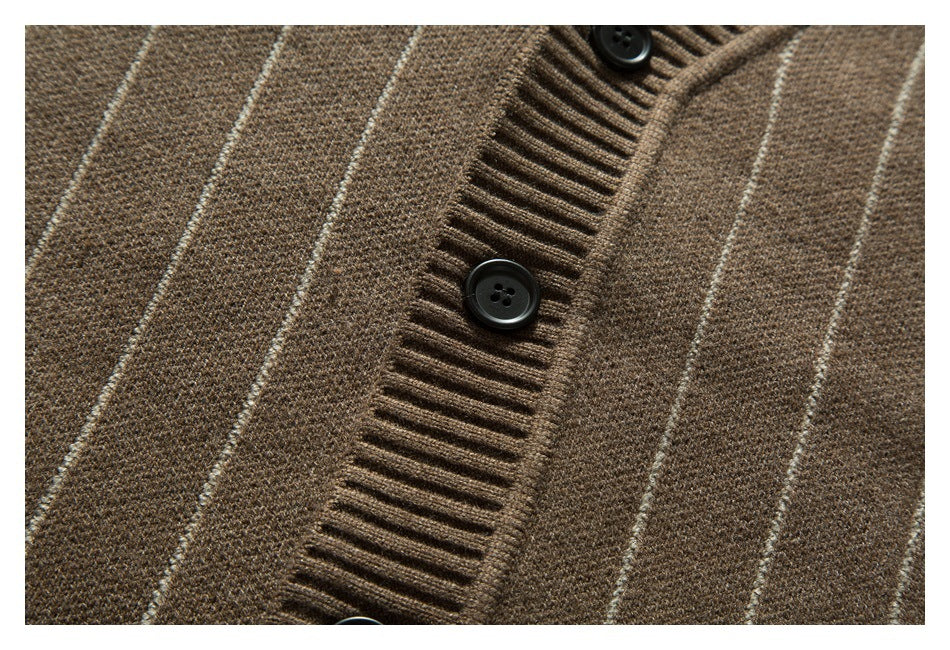 Close-up of a brown striped knit cardigan placket with dark buttons and ribbed trim.