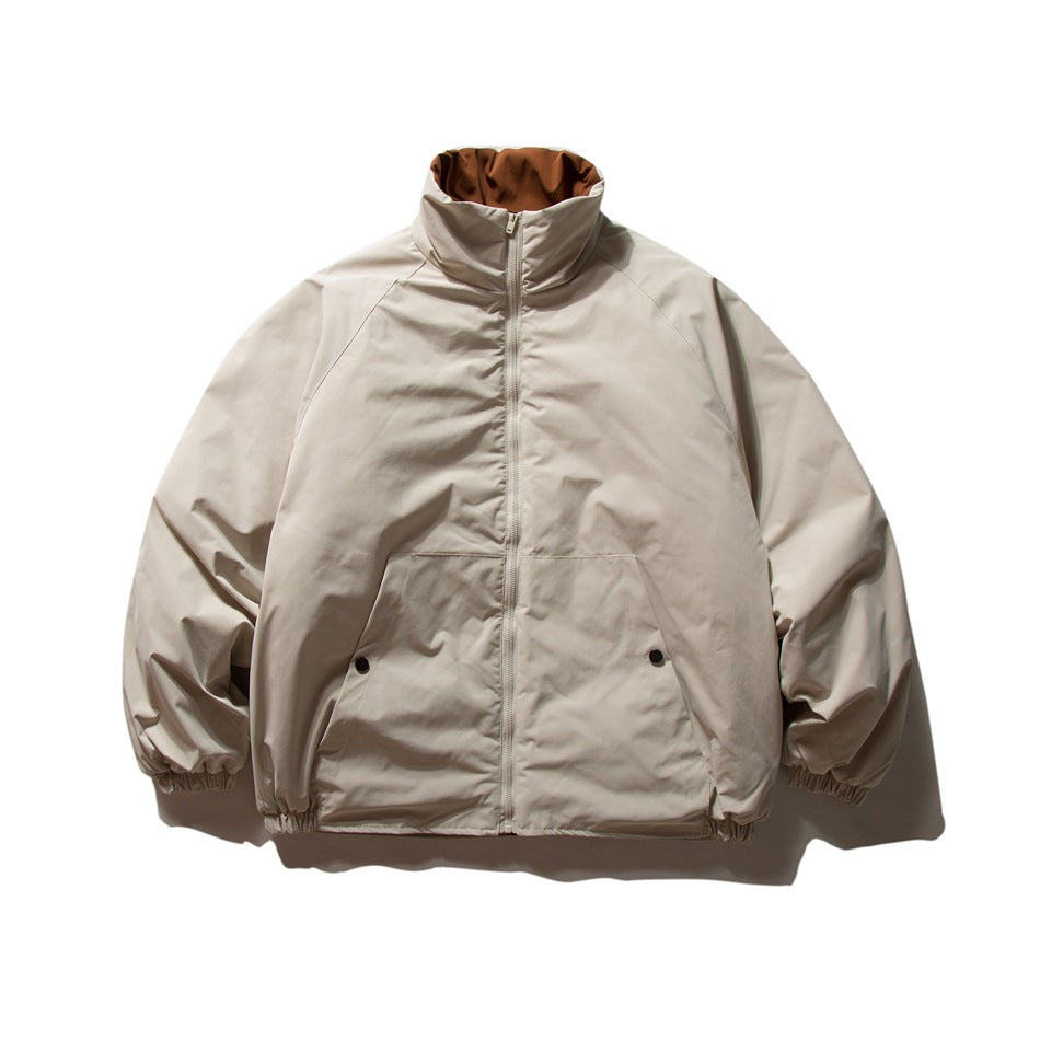 Beige stand-collar zip-front jacket with raglan sleeves, front pocket panel and elastic cuffs, flat lay
