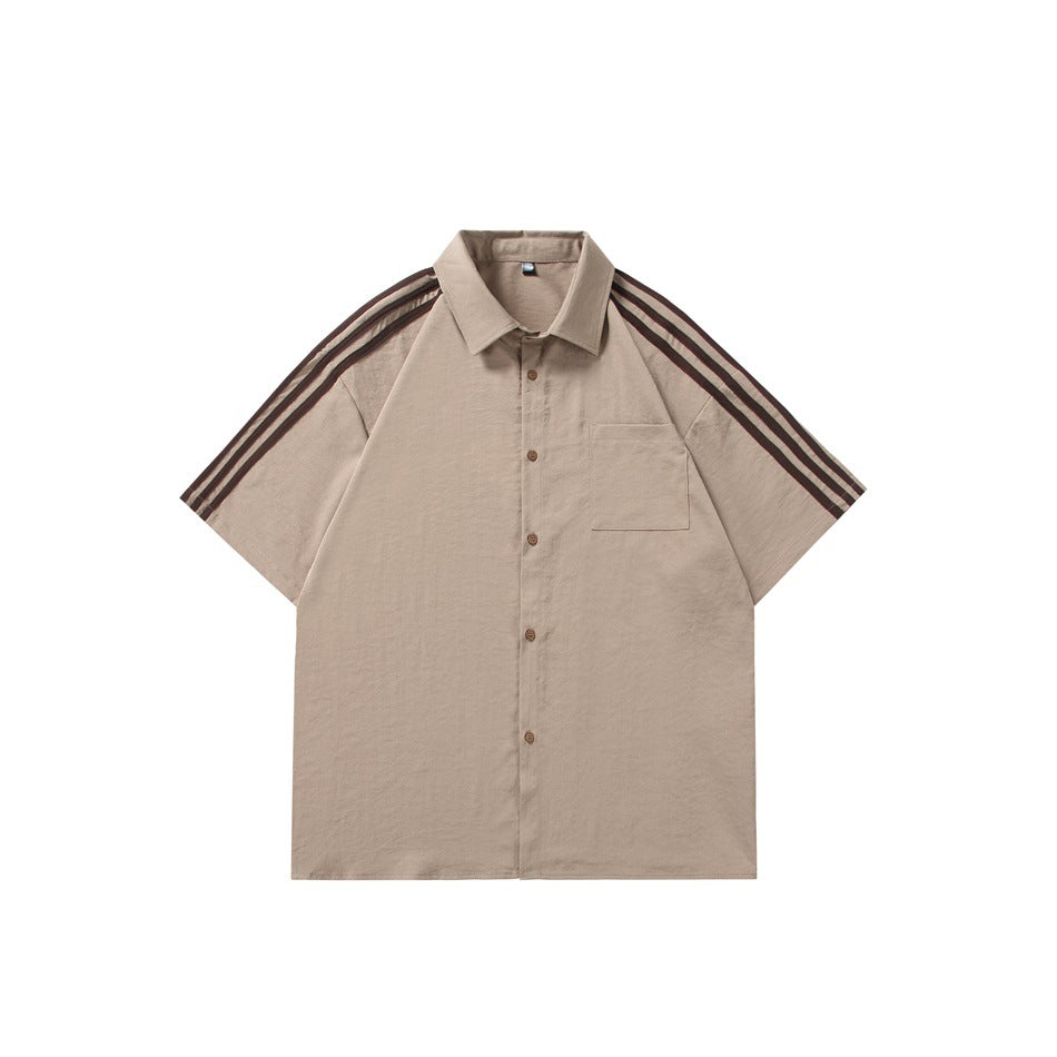 Front view of a tan short-sleeve collared button-up shirt with a chest pocket and dark shoulder stripes.