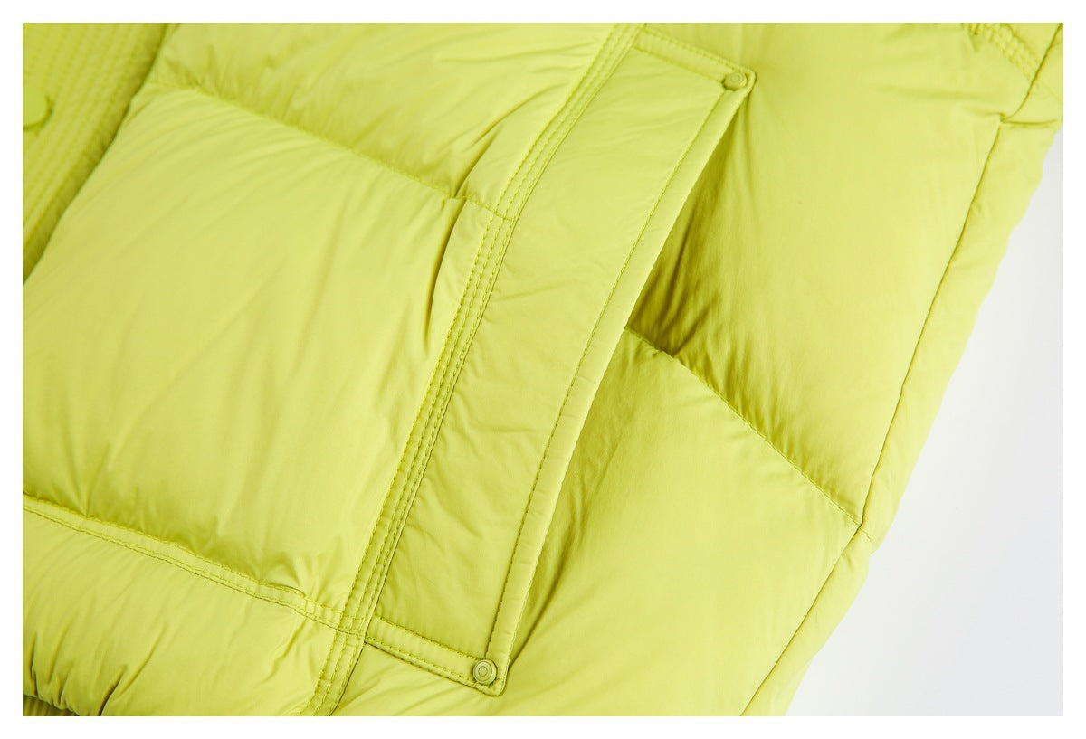 Close-up of a chartreuse padded jacket pocket flap with matching stitching and a snap button.