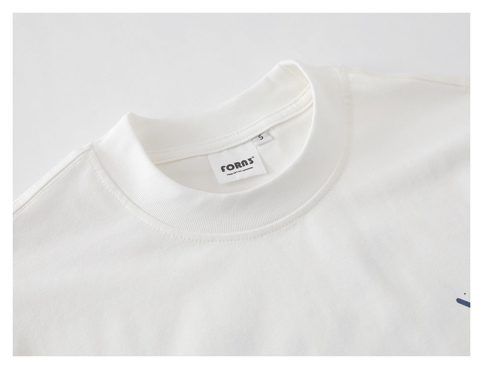 Close-up of a white T-shirt’s ribbed crew neck, shoulder seam, and inner neck label.